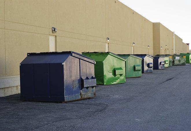 a group of dumpsters lined up along the street ready for use in a large-scale construction project in Bonsall